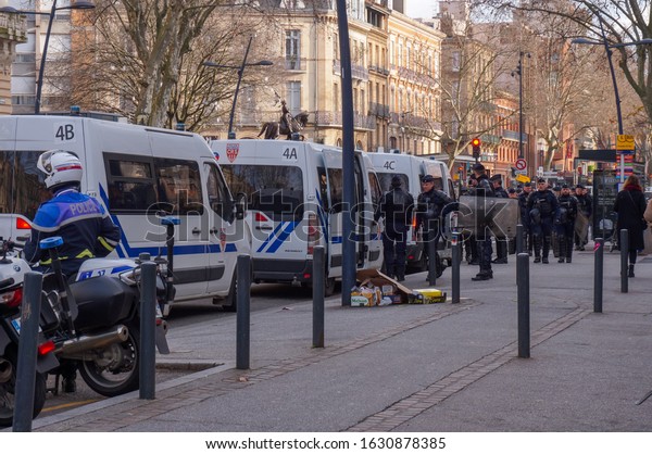 Toulouse, France - Jan. 2020 - A police convoy\
escorted by a CRS motorcyclist brings back heavily equipped riot\
officers, at the end of an operation in a demonstration against the\
pension reform