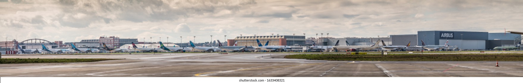 Toulouse, France - Januar 2020 Panoramic View Of  Airbus Plant, Toulouse Blagnac Airport (TLS, LFBO), With A Lot Of New Build Airplanes Parked Around The Hangers