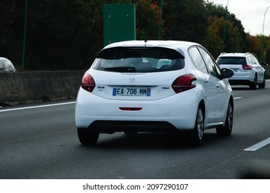 Toulouse, France - June 2021 - A 2012 , white Peugeot 208, a small model of compact car produced by the French manufacturer PSA Peugeot-Citroën in Mulhouse and Poissy, driving on the motorway