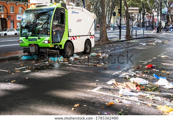 Toulouse, France. October 27, 2019.\
Street sweeper is cleaning heavily polluted streets after the\
seasonal market. Urban pollution and plastic in\
cities.