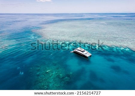 Tour boat with divers and snorkellers on the Great Barrier Reef in Far North Queensland. Cairns, Australia.