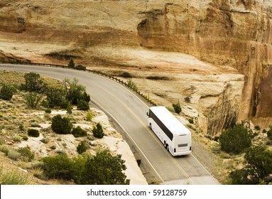 A tour bus drives through the scenery along the Rim Rock Drive in Colorado National Park.