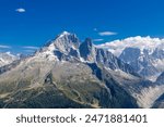 Tour du Montblanc beautiful mountain ladscapes of the Alps green valley, snow summit of Montblanc and rocky peaks of Aiguille du Midi in summer sunny weather blue sky, trekking and hiking in Chamonix