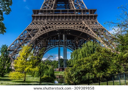 Similar – Eiffel Tower in green trees on blue sky