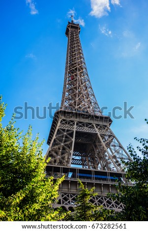 Similar – Eiffel Tower in green trees on blue sky