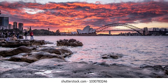 Tour Group People Is Watching Amazing Beautiful Burning Red Sunset Sky Above Opera House And Harbour Bridge From Mrs. Macquaries Chair, Sydney 22/02/18