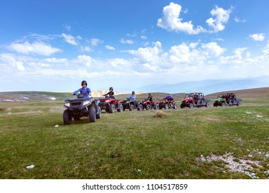 A Tour Group Travels On ATVs And UTVs On The Mountains