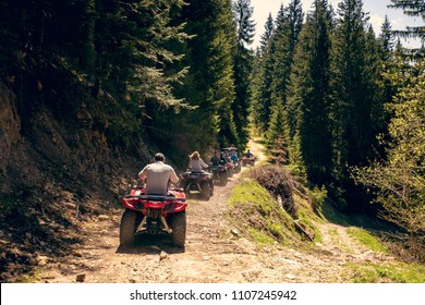 A tour group travels on ATVs and UTVs on the mountains