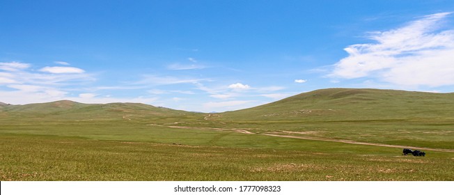 Tour Guides Parked On A Track On A Mongolian Grassland