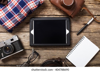 Tourism concept - set of stuff with camera and other travel things on wooden table background