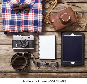 Tourism concept - set of stuff with camera and other travel things on wooden table background