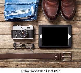 Tourism concept - set of stuff with camera and other travel things on wooden table background
