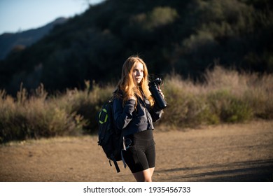 Tourism Concept. Woman Hiker With Backpack At Hills. Tourist Girl Hiking In Mountains With Backpacking Tools. Active Lifestyle