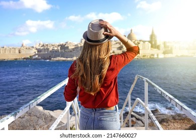 Tourism In Europe. Back View Of Traveler Girl Walking On Stairs Enjoying View Of Valletta City, Malta. Young Female Tourist Visiting Southern Europe.