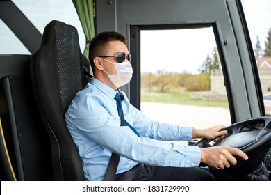 Tourism, Health And People Concept - Male Driver Wearing Face Protective Medical Mask For Protection From Virus Disease Driving Travel Bus