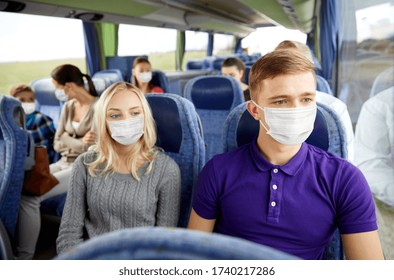 tourism, healthcare and pandemic concept - couple with group of passengers or tourists wearing face protective medical mask for protection from virus disease in travel bus