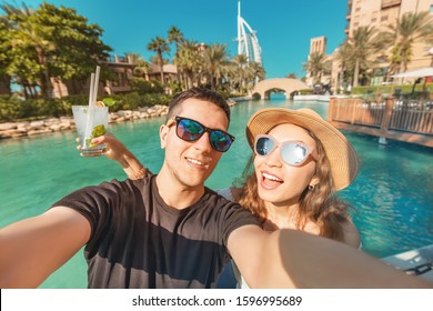 Tourism and holiday resorts - a couple in love during their honeymoon taking a selfie photo in Dubai, UAE