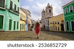 Tourism in Salvador de Bahia. Back view of traveler girl descends famous Pelourinho historic center of Salvador de Bahia, UNESCO World Heritage, Brazil.