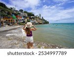 Tourism in Salvador de Bahia, Brazil. Beautiful traveler girl enjoying view of Gamboa de Baixo neighborhood and Bay of All Saints in Salvador de Bahia, Brazil.