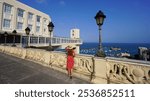 Tourism in Salvador de Bahia, Brazil. Panoramic banner view of tourist woman on terrace enjoying viewpoint with Lacerda Elevator of Salvador de Bahia, Brazil.