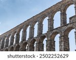 Tourism in Segovia, ancient Roman aqueduct in the Plaza del Azoguejo in Spain.