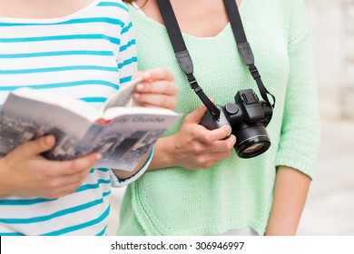 Tourism, Travel, Leisure And Friendship Concept - Close Up Of Women With City Guide And Camera Outdoors