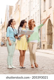 Tourism, Travel, Leisure, Holidays And Friendship Concept - Smiling Teenage Girls With Map And Camera Outdoors