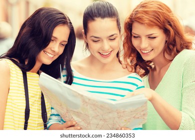 Tourism, Travel, Leisure, Holidays And Friendship Concept - Smiling Teenage Girls With Map And Camera Outdoors