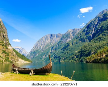 Tourism And Travel. Mountains And Fjord Sognefjord In Norway, Scandinavia. Old Viking Boat On Seashore.