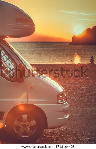 Tourism vacation and travel.\
Camper van on nature at sunrise over sea surface, Greece\
Peloponnese.