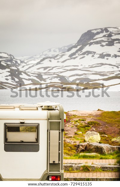 Tourism vacation and travel.\
Camper van motorhome on camping site rest place in norwegian\
mountains