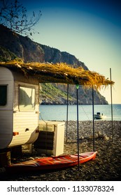 Tourism Vacation And Travel. Caravan Trailer On Sunny Beach In Greece