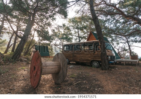 Tourism vacation and travel. Old colorful retro\
camper on camping site at beautiful rocky coastal landscape of\
Mediaterian, Turkey.