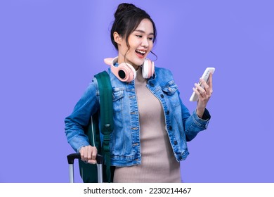 Tourist asian woman in casual clothes hat hold suitcase using mobile cell phone sit isolated on colour background Passenger travel abroad weekends . - Powered by Shutterstock