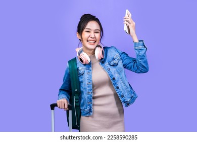 Tourist asian woman in casual clothes hat hold suitcase using mobile cell phone sit isolated on colour background Passenger travel abroad weekends . - Powered by Shutterstock