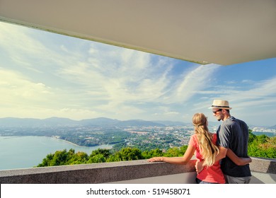 Tourist Attraction. Couple Of Travelers Enjoying Sea, City And Sky On The View Point.