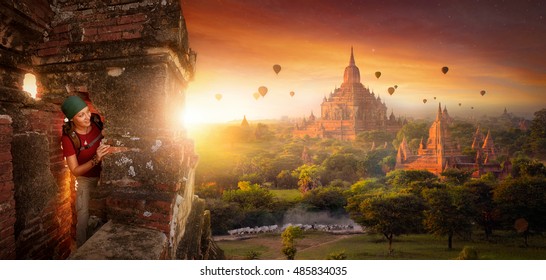 tourist with a backpack explores the ancient temple on a background of beautiful sunrise with balloons. Bagan, Myanmar.
Traveling along Asia, active lifestyle concept. - Powered by Shutterstock