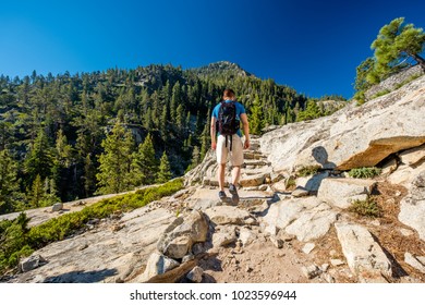 Tourist With Backpack Hiking In Mountains At Lake Tahoe In California, USA