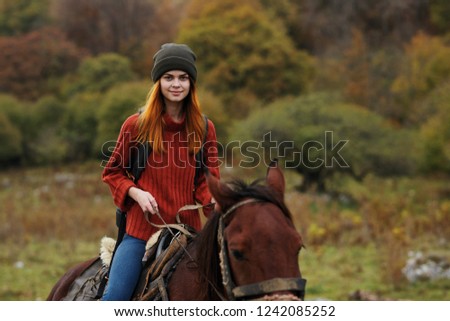 Tourist with a backpack on his back riding a horse                           