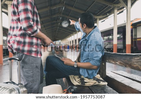 Tourist with backpack wait for train and ask for direction help.