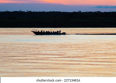 Tourist Boat Cross The Amazon River At The Sunset. Iquitos, Peru