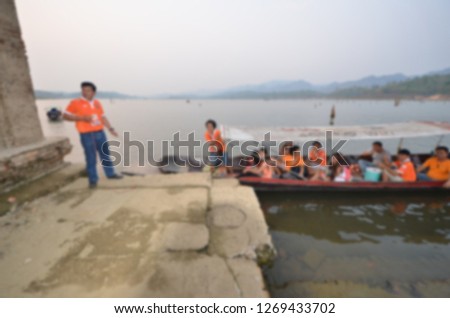 Tourist boat docks at shore of landmark