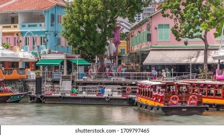 Tourist boats docking at Clarke Quay habour view with colorful houses. Clarke Quay is a historical riverside quay in Singapore, located within the Singapore River Planning Area. - Powered by Shutterstock