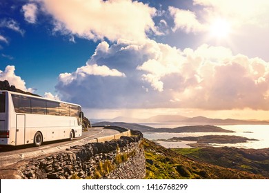 Tourist Bus Traveling On Mountain Road. Ring Of Kerry, Ireland. Travel Destination
