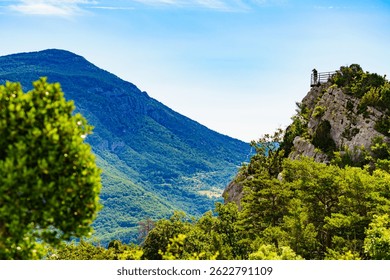 Tourist with camera on viewpoint Col d'Illoire near Aiguines village. Verdon Gorge in French Alps, Provence France. Mountain landscape.
