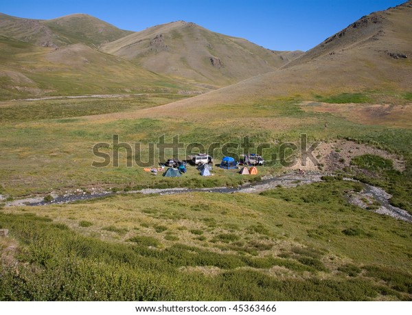 The tourist\
camp in the mountains, tents and\
cars