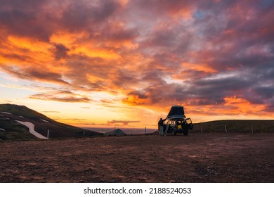 Tourist camper car parked with beautiful sunset sky on top of mountain in Icelandic Highlands on summer at Iceland