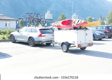 a tourist car with a trailer, bicycles and kayaks parked next to the hotel, theme and active sports and family vacations
 - Powered by Shutterstock