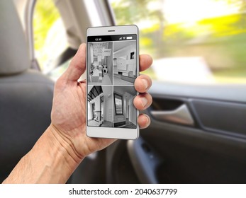 Tourist In Car Watching CCTV Footage From House Security System On Smartphone