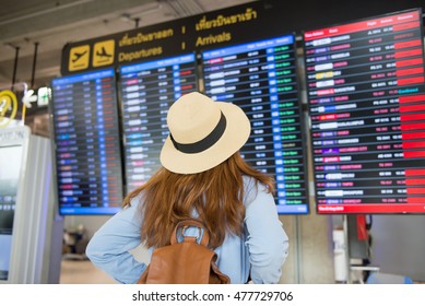 Tourist is checking time table of flight at the airport. - Shutterstock ID 477729706